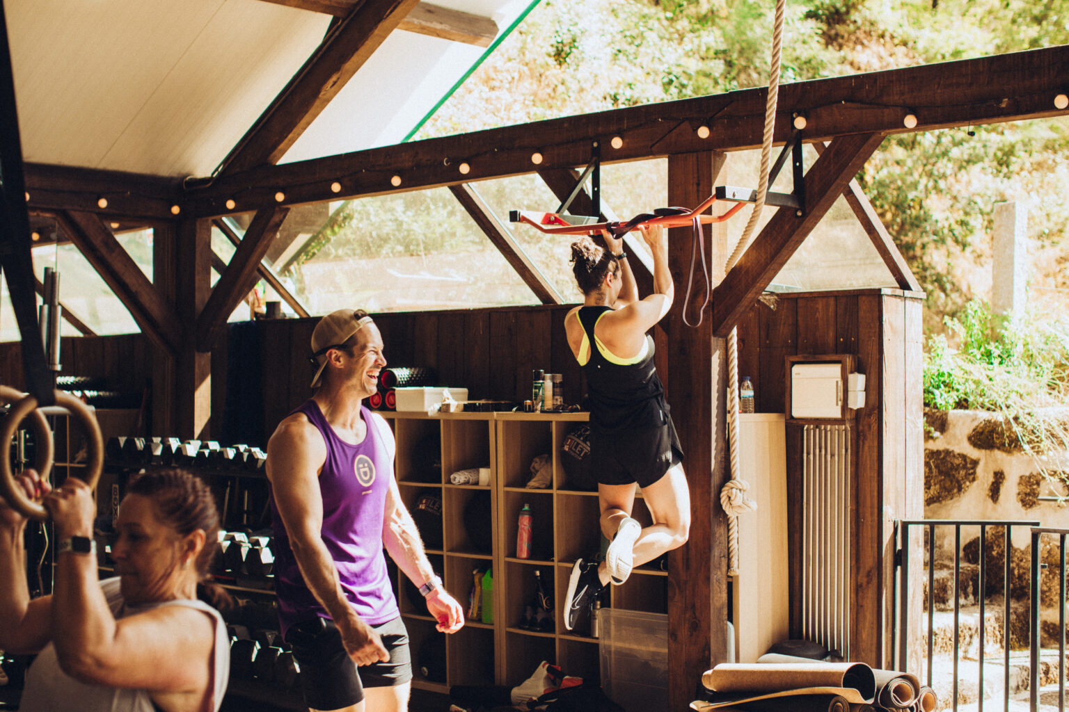 Guests training on gymnastic rings in the open-air timber gym