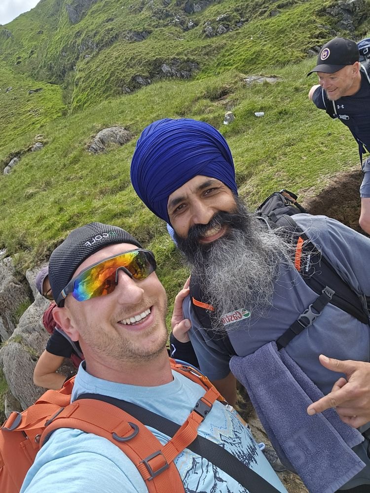 Two hikers smiling for a selfie on the mountain